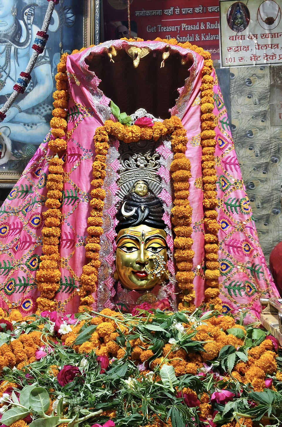 Deity adorned with flowers and garlands