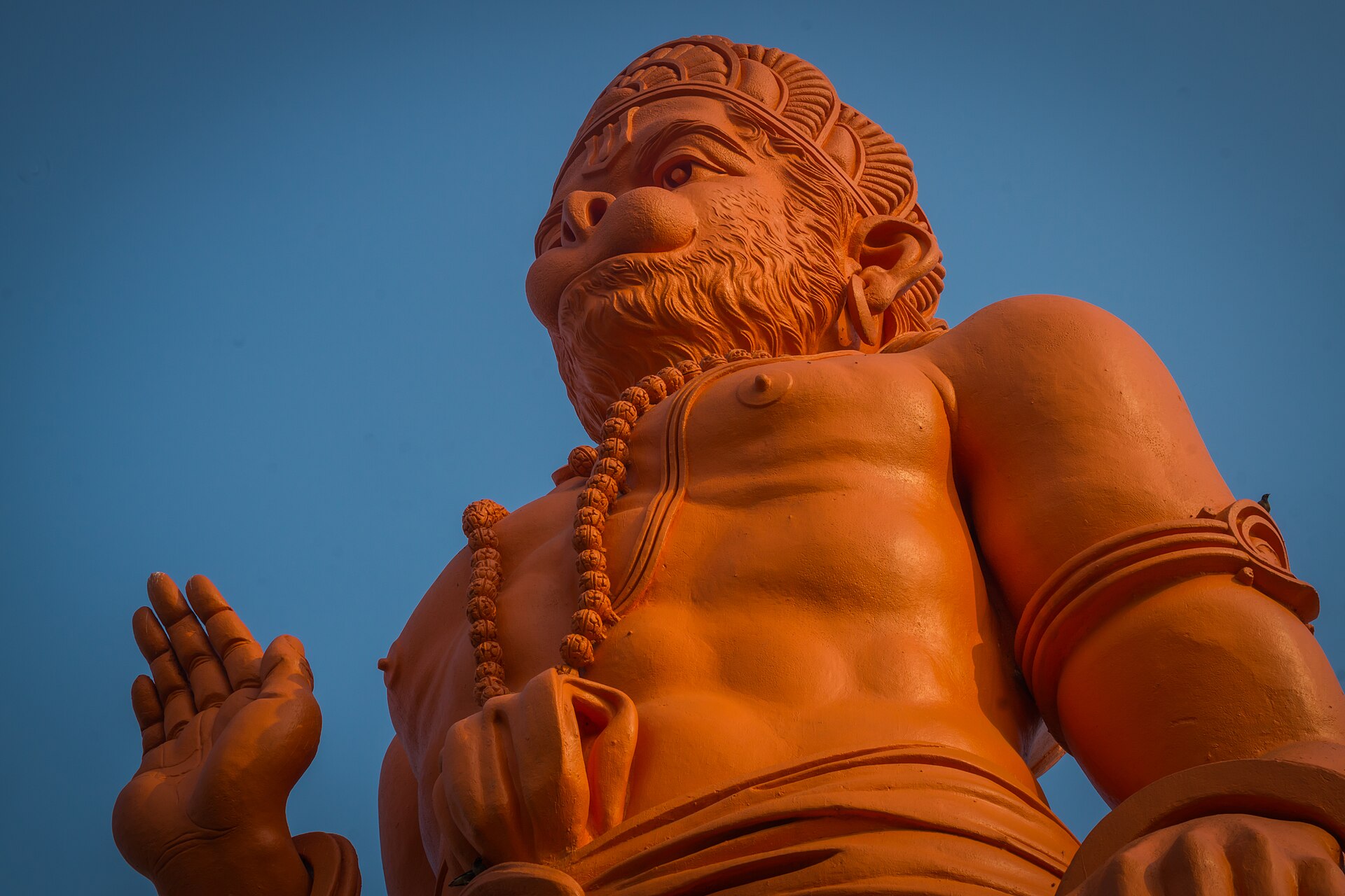Towering saffron murti of Lord Hanuman raising his hand in blessing